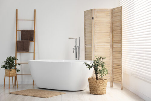 Spa-like bathroom remodel with freestanding tub and natural wood accents
