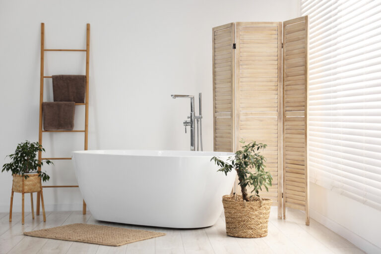 Spa-like bathroom remodel with freestanding tub and natural wood accents