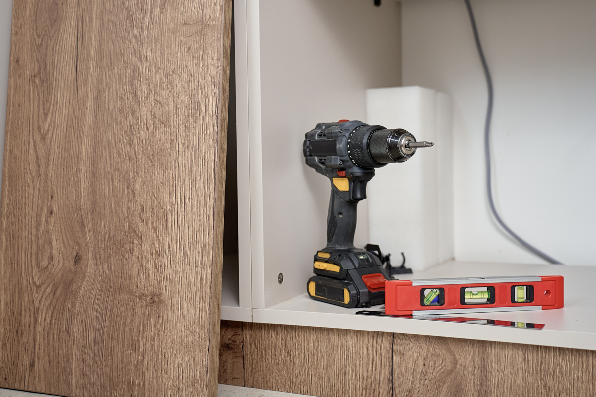 Kitchen remodel cost Miami cabinet installation with drill and level