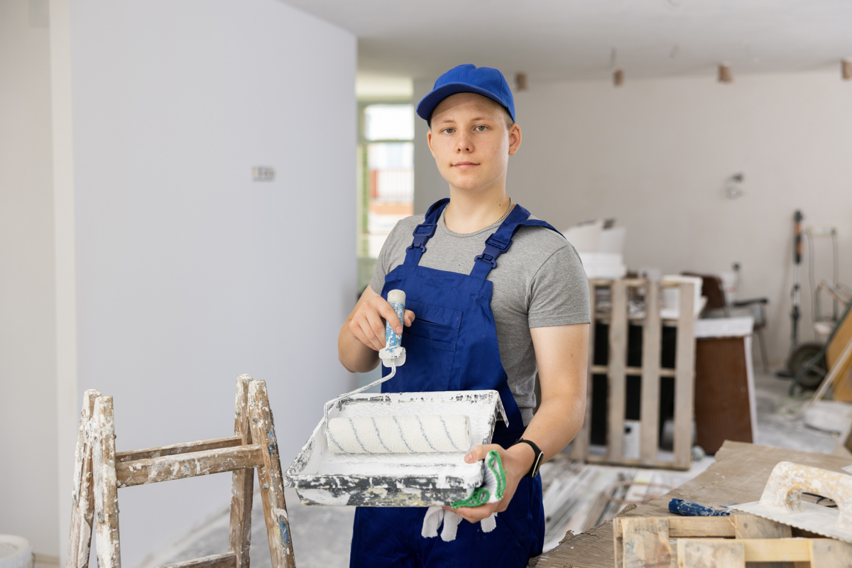 Contractor painting interior during Miami home renovation project