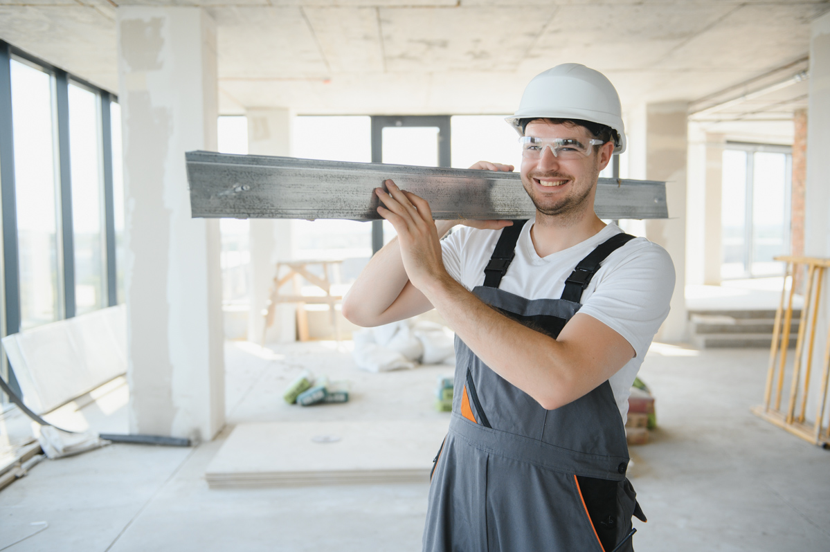 Contractor during popcorn ceiling asbestos removal prep in home renovation