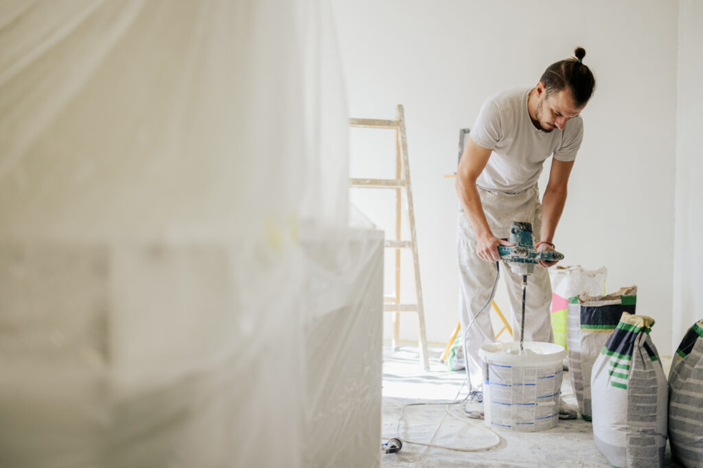 Contractor mixing material during home renovation work