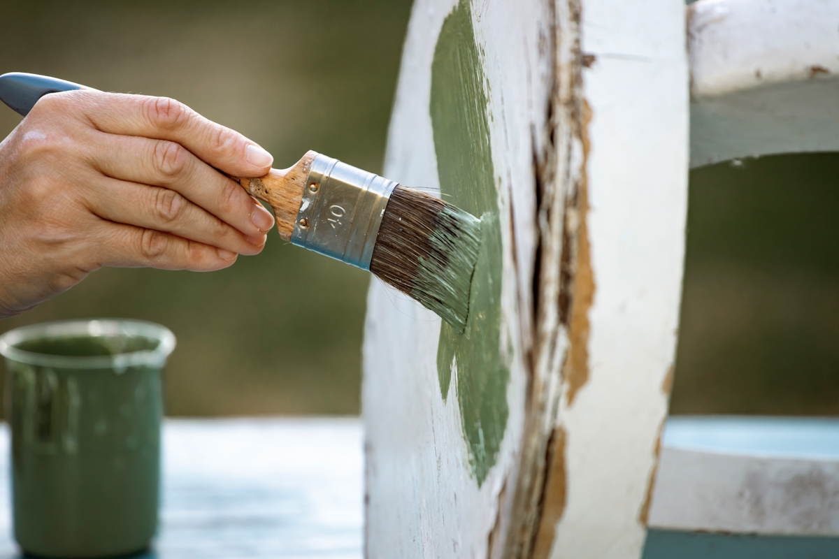 Painting damaged wood trim during home renovation