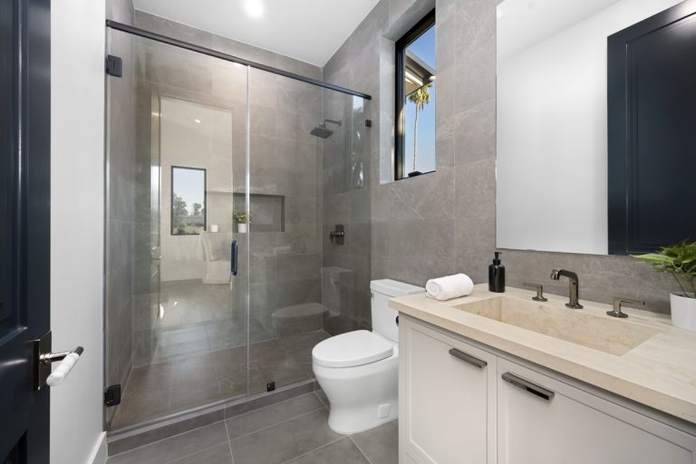 Modern bathroom tile flooring with walk-in shower and gray tile