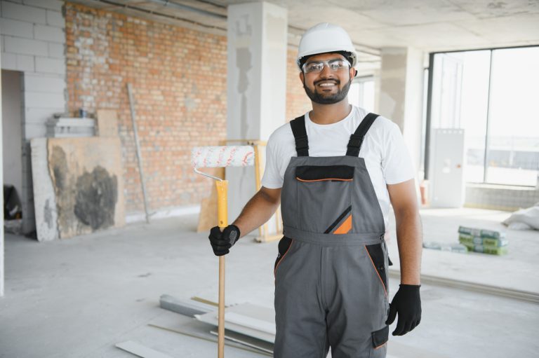 Contractor at renovation site with vinyl plank flooring materials