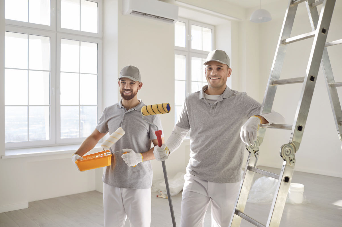 Contractors in room with vinyl plank flooring during renovation