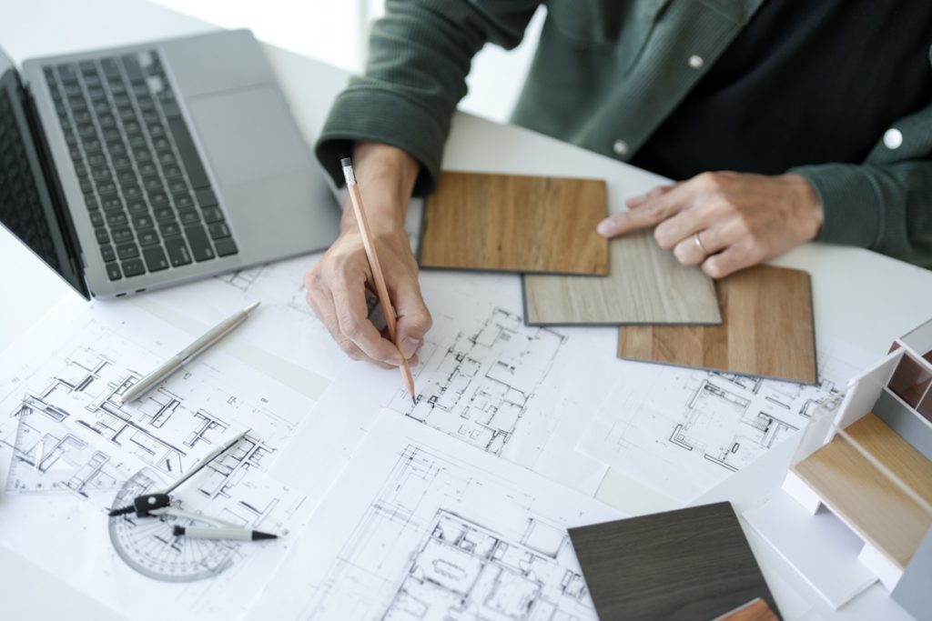 General contractor reviewing blueprints and flooring samples