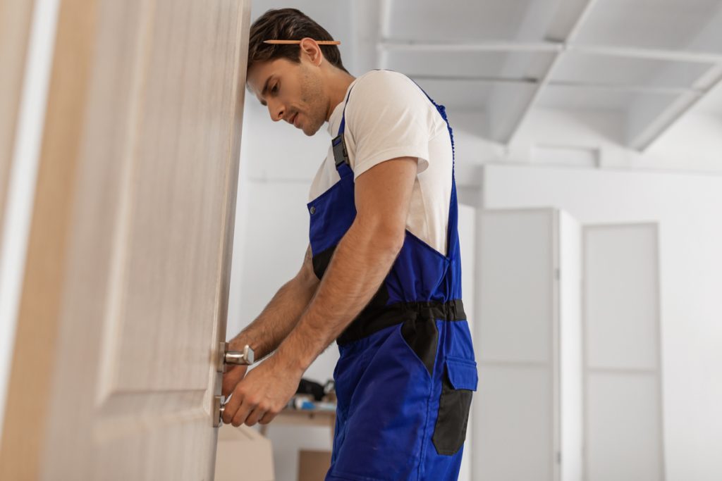 Contractor begins door removal by loosening interior handle