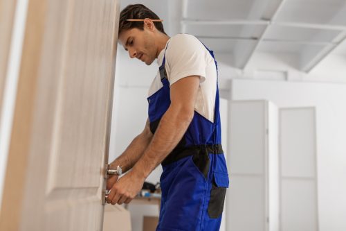 Contractor begins door removal by loosening interior handle